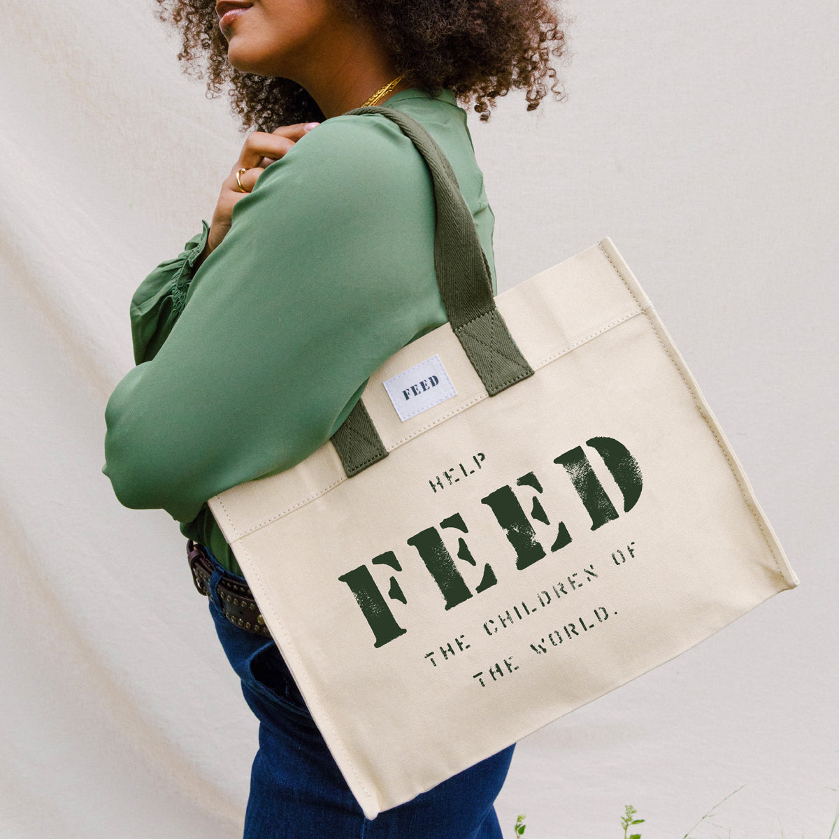 Sand | Lifestyle of sand FEED 10 tote bag with FEED the Children of the World text.